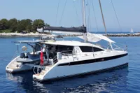 Luxury Privilege 515 catamaran yacht anchored in serene blue waters, 2010 model.
