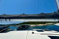 Sailing yacht Privilege 515, 2010 model, docked in a scenic coastal area.