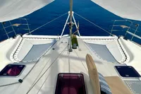 Catamaran deck view, Privilege 515, 2010 model, sailing on clear blue ocean.