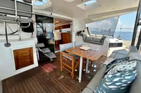 Luxurious 2010 Privilege 515 yacht interior with elegant seating and ocean view.