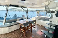 Luxurious 2010 Privilege 515 yacht interior with seating, table, and ocean view.