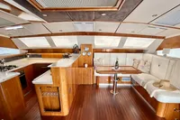 Luxurious interior of 2010 Privilege 515 yacht with elegant wood and white furnishings.