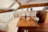 Luxurious interior of 2010 Privilege 515 yacht with elegant seating and champagne.