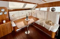 Luxurious interior of 2010 Privilege 515 yacht with elegant seating and wooden table.