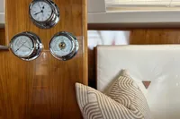 Wooden yacht interior with nautical instruments and striped cushions, Privilege 515, 2010 model.