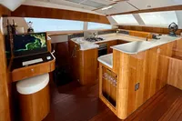 Luxurious 2010 Privilege 515 yacht interior with modern kitchen and navigation station.