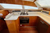 Luxurious 2010 Privilege 515 yacht kitchen with modern appliances and wooden cabinetry.