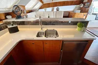 Luxurious kitchen interior on a 2010 Privilege 515 yacht, featuring modern amenities and elegant design.