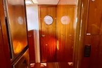 Luxurious wooden interior of 2010 Privilege 515 yacht cabin hallway.