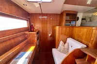 Luxurious interior of 2010 Privilege 515 yacht with wooden finish and cozy seating.