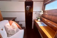 Luxurious interior of 2010 Privilege 515 yacht with elegant wood finish and comfortable seating.