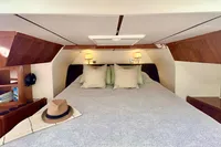 Luxurious cabin interior of 2010 Privilege 515 yacht with cozy bed and elegant decor.