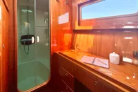 Luxurious 2010 Privilege 515 yacht interior with wooden cabinetry, shower, and window.