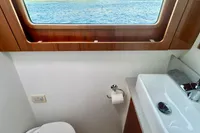 Luxurious Privilege 515 yacht bathroom with ocean view, modern sink, and wooden accents.