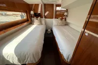 Luxurious twin cabin interior on 2010 Privilege 515 yacht with wooden finishes.