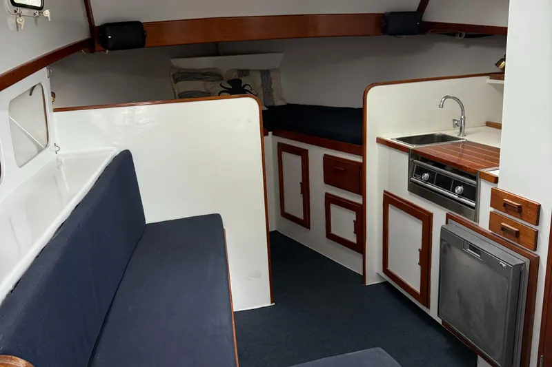 Salty Dog Yacht Photos Pics Interior of a 1993 Young Brothers 38 boat with kitchenette and seating area.