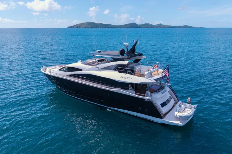  Yacht Photos Pics 2017 Sunseeker 86 Yacht cruising on blue ocean with distant islands.