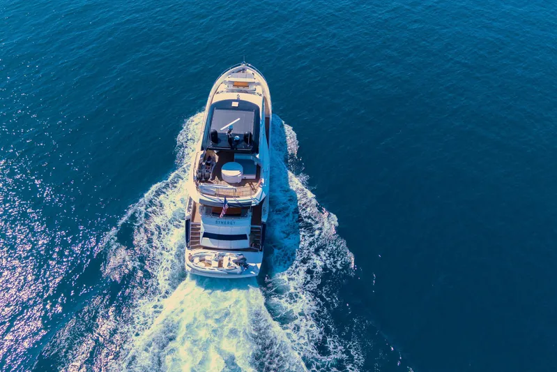  Yacht Photos Pics Aerial view of 2017 Sunseeker 86 Yacht cruising on open blue water.