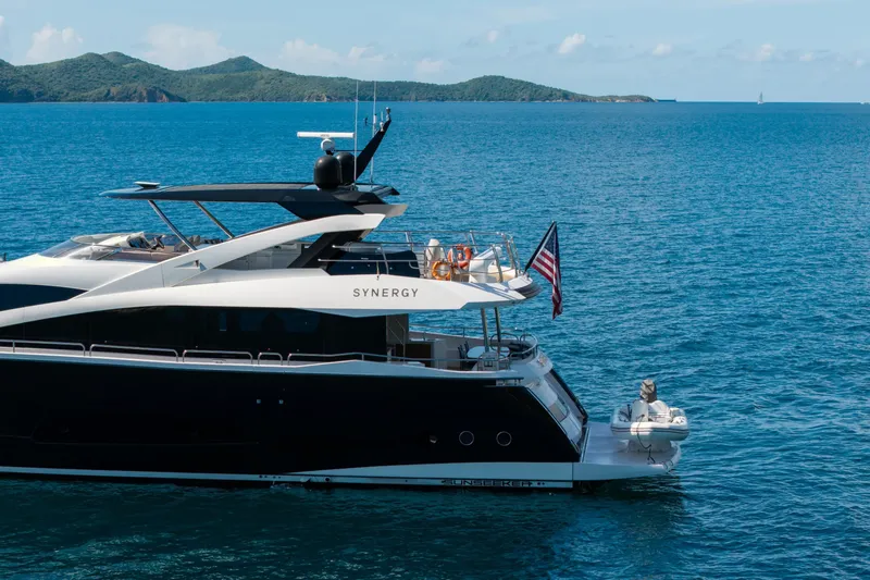  Yacht Photos Pics 2017 Sunseeker 86 Yacht on blue ocean with scenic island backdrop.