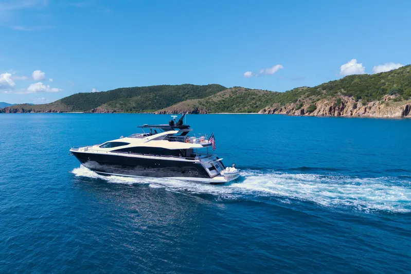  Yacht Photos Pics 2017 Sunseeker 86 Yacht cruising in clear blue waters near a scenic coastline.