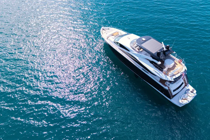  Yacht Photos Pics Aerial view of 2017 Sunseeker 86 Yacht on sparkling blue water.