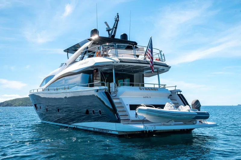  Yacht Photos Pics Luxurious 2017 Sunseeker 86 Yacht on serene blue waters, featuring sleek design and American flag.