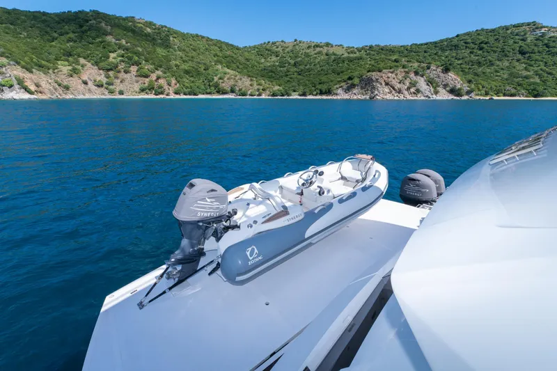  Yacht Photos Pics 2017 Sunseeker 86 Yacht with Zodiac tender on deck, scenic coastal backdrop.