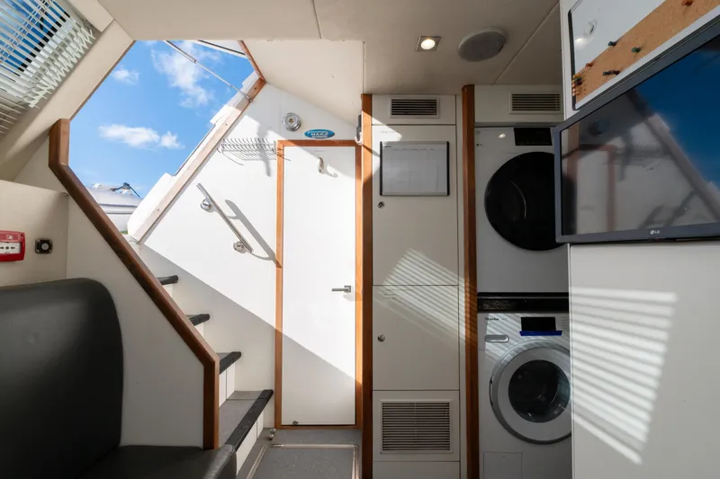  Yacht Photos Pics Interior of 2017 Sunseeker 86 Yacht with stairs, laundry, and TV.