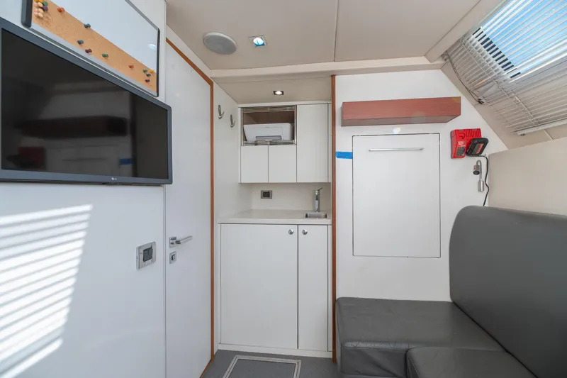  Yacht Photos Pics Interior of 2017 Sunseeker 86 Yacht with modern kitchenette and seating area.