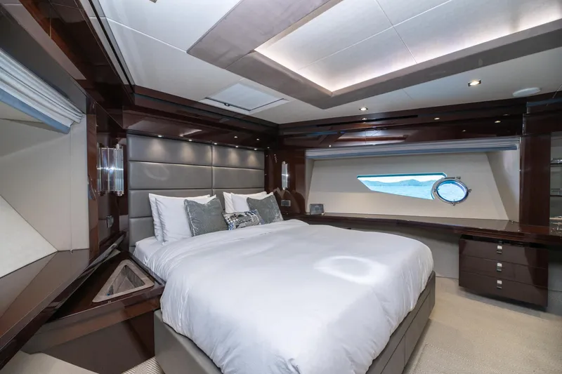  Yacht Photos Pics Luxurious bedroom interior of 2017 Sunseeker 86 Yacht with elegant furnishings and ocean view.