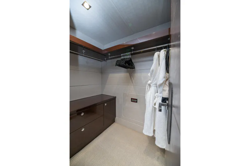  Yacht Photos Pics Luxurious walk-in closet on 2017 Sunseeker 86 Yacht with robes and hangers.