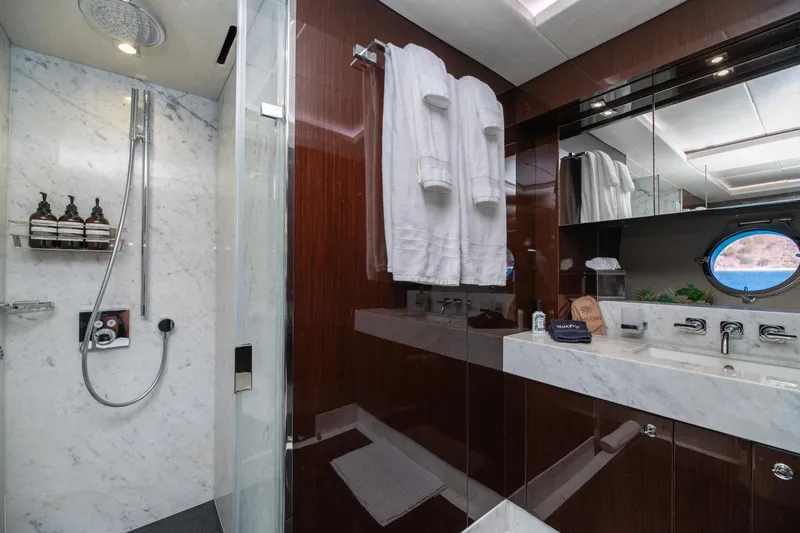  Yacht Photos Pics Luxurious bathroom on 2017 Sunseeker 86 Yacht with marble shower and elegant fixtures.