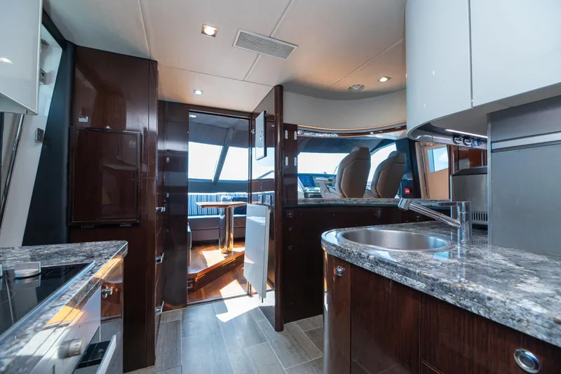 Yacht Photos Pics Luxurious interior of 2017 Sunseeker 86 Yacht with modern kitchen and sleek design.