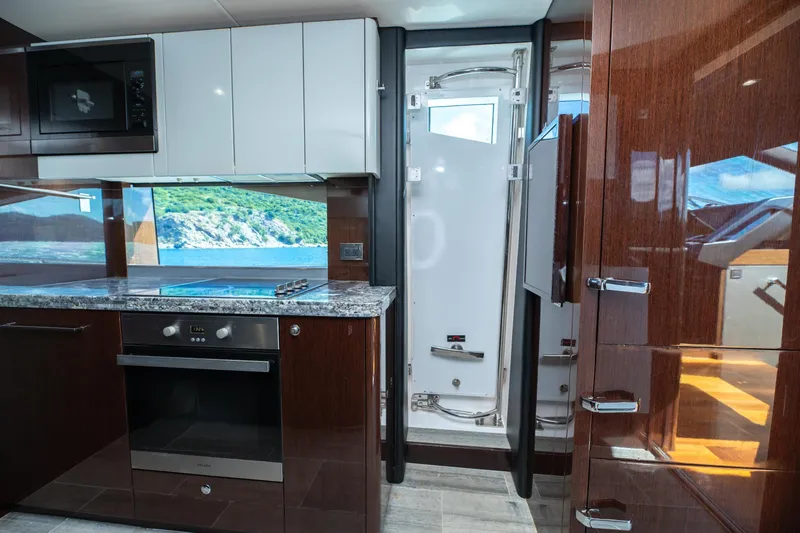  Yacht Photos Pics Luxurious kitchen interior of 2017 Sunseeker 86 Yacht with modern appliances and ocean view.