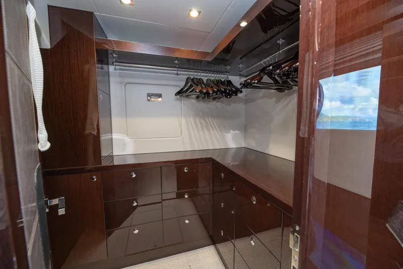  Yacht Photos Pics Luxurious walk-in closet on 2017 Sunseeker 86 Yacht with sleek wood finish.
