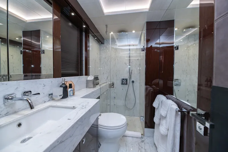  Yacht Photos Pics Luxurious marble bathroom on 2017 Sunseeker 86 Yacht, featuring modern fixtures and elegant design.