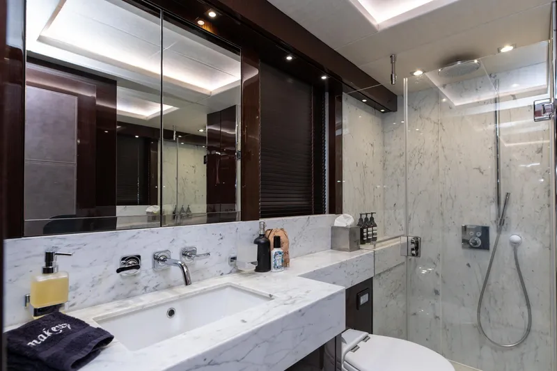  Yacht Photos Pics Luxurious marble bathroom in 2017 Sunseeker 86 Yacht, featuring modern fixtures and elegant design.