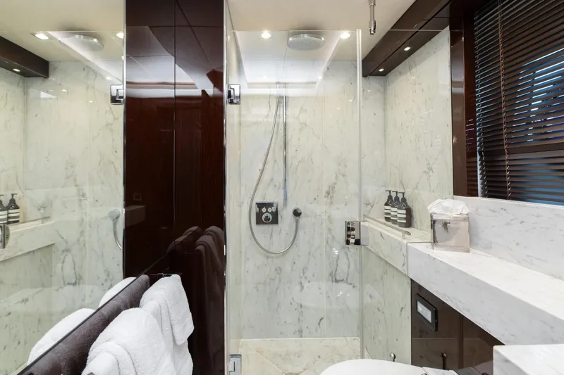  Yacht Photos Pics Luxurious marble bathroom on 2017 Sunseeker 86 Yacht with glass shower enclosure.