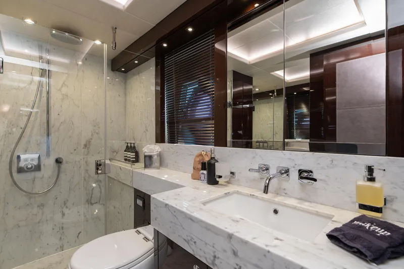  Yacht Photos Pics Luxurious marble bathroom in 2017 Sunseeker 86 Yacht, featuring modern fixtures and elegant design.