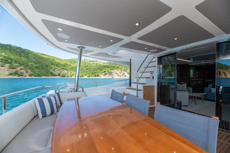  Yacht Photos Pics Luxurious 2017 Sunseeker 86 Yacht deck with elegant dining area and scenic ocean view.