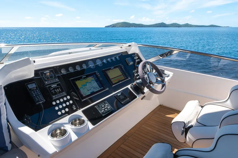  Yacht Photos Pics Cockpit of 2017 Sunseeker 86 Yacht with navigation controls, overlooking serene ocean view.