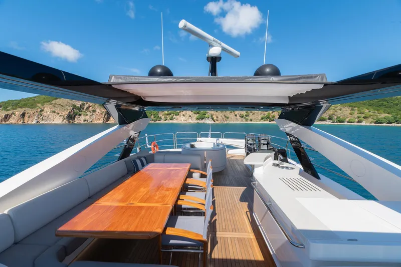  Yacht Photos Pics Luxurious 2017 Sunseeker 86 Yacht deck with dining area, overlooking serene coastal waters.