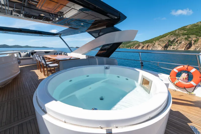  Yacht Photos Pics Luxurious 2017 Sunseeker 86 Yacht deck with jacuzzi and dining area, scenic ocean view.