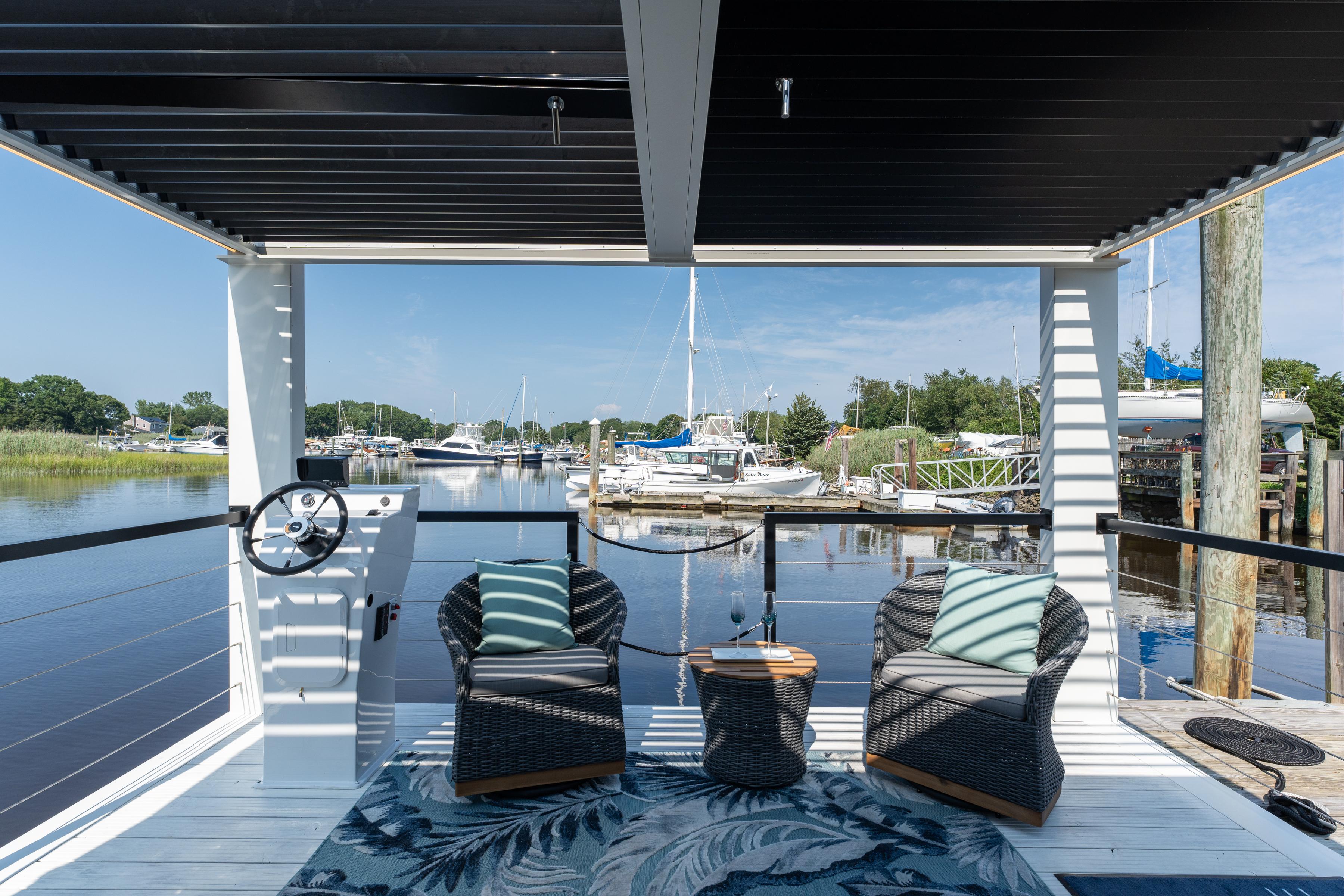 Modern Waterlodge 11 houseboat with cozy seating, overlooking a serene marina view.