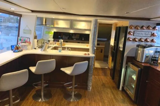 The Jobsite Yacht Photos Pics Luxurious interior of a 1988 Viking Motor Yacht with modern kitchen and bar stools.