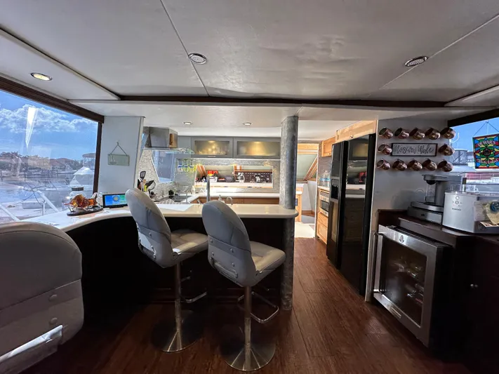 The Jobsite Yacht Photos Pics 1988 Viking Motor Yacht interior with modern kitchen and bar stools.