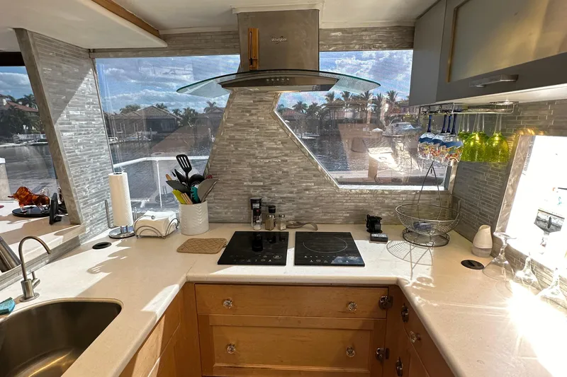 The Jobsite Yacht Photos Pics Modern kitchen in a 1988 Viking Motor Yacht with sleek countertops and large windows.