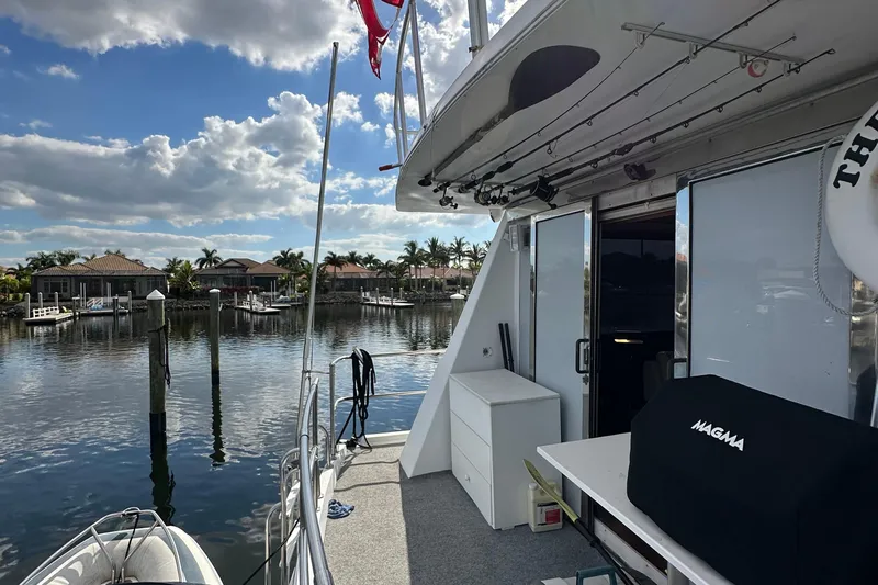 The Jobsite Yacht Photos Pics 1988 Viking Motor Yacht docked at a marina with a scenic waterfront view.