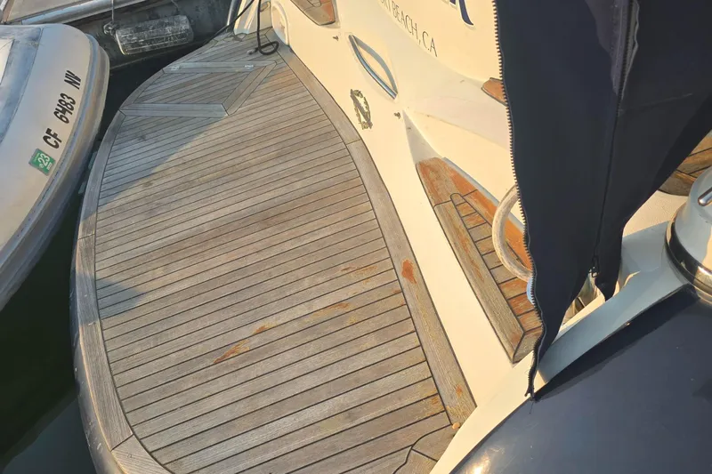 Kings Corner Yacht Photos Pics 2001 Sunseeker Camargue 44 yacht with wooden deck, docked at marina.