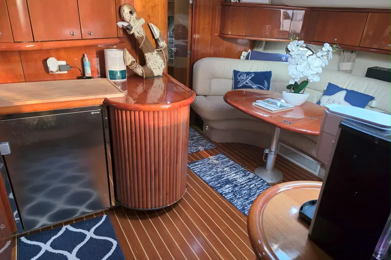 Kings Corner Yacht Photos Pics Luxurious interior of 2001 Sunseeker Camargue 44 yacht with elegant wood finishes and cozy seating.